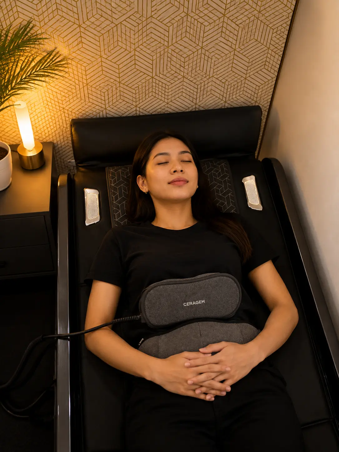 Woman using the CERAGEM thermal care belt during an evening recovery session